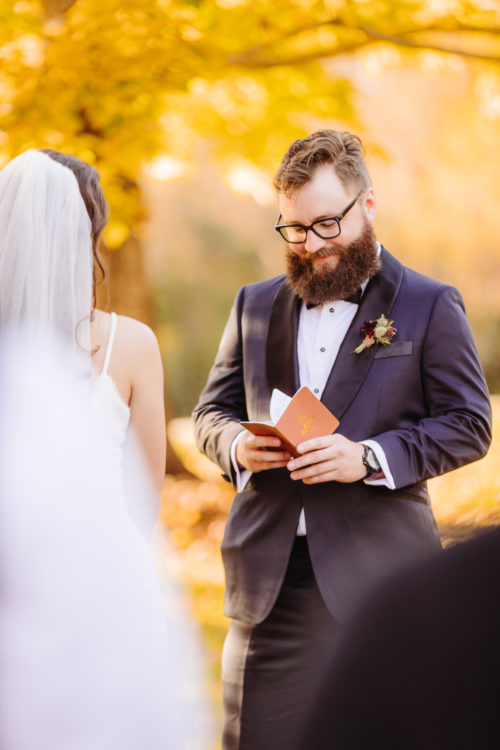 Groom reads vows at fall elopement 