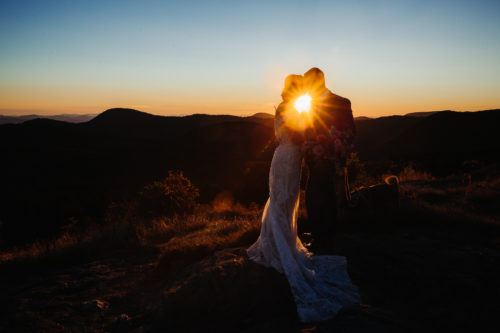 Couple embraces at elopement on mountain
