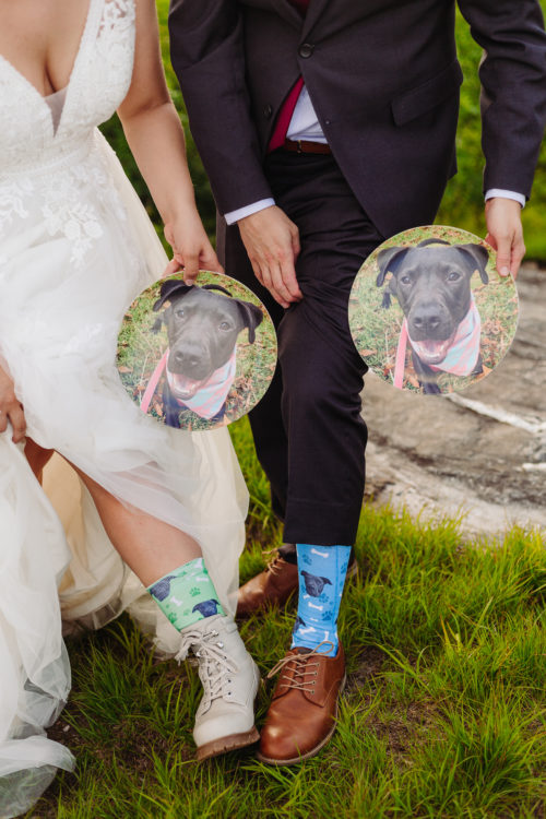Bride and Groom show off socks and plates with their dog's face on it 