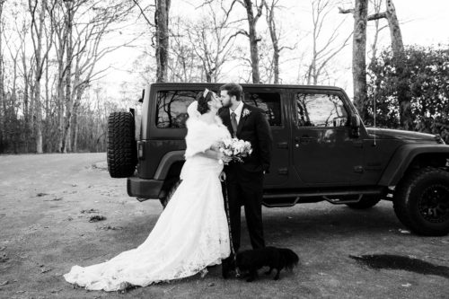 Couple in the parking lot by Jeep after wedding
