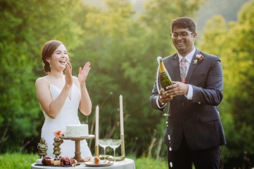 Groom pops champagne at elopement