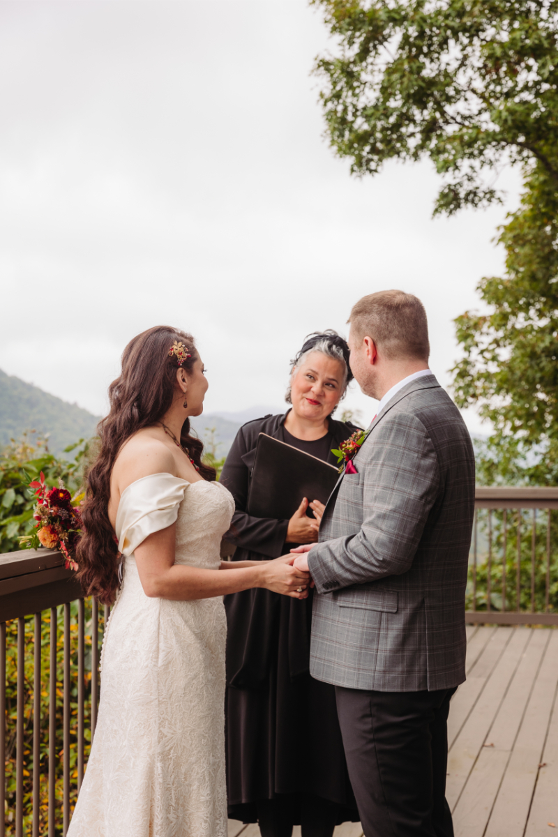 Bride and groom exchange vows in the mountains of North Carolina with the help of an all-inclusive outdoor elopement planner.