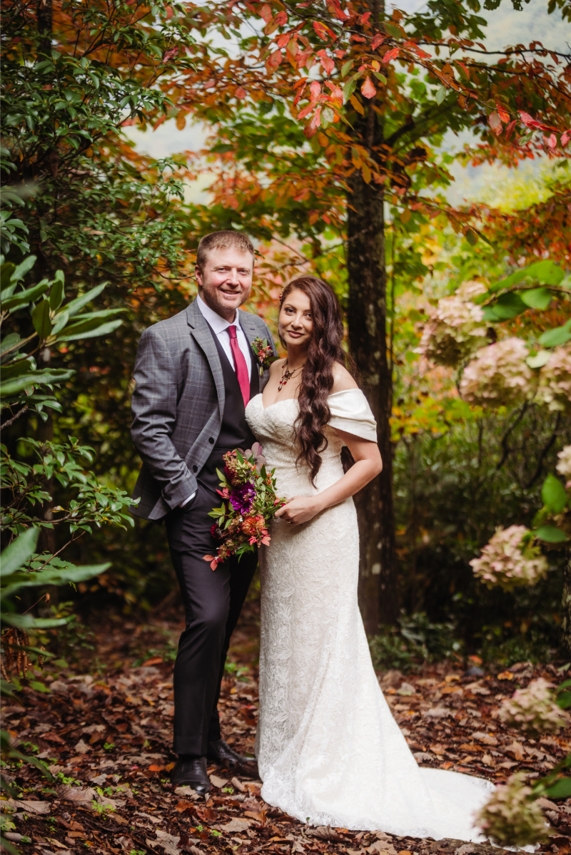 Bride and groom pose in the woods of North Carolina during an outdoor elopement.