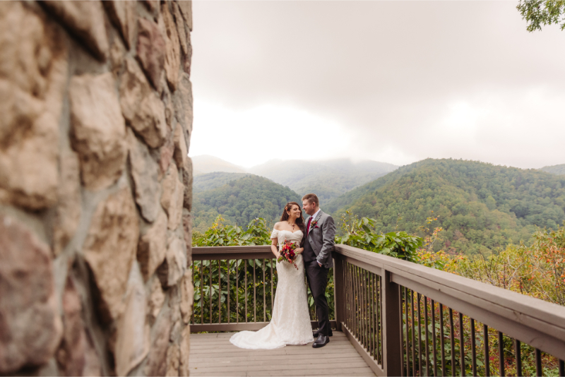 Bride and groom taking wedding portraits with the North Carolina mountains in the background.