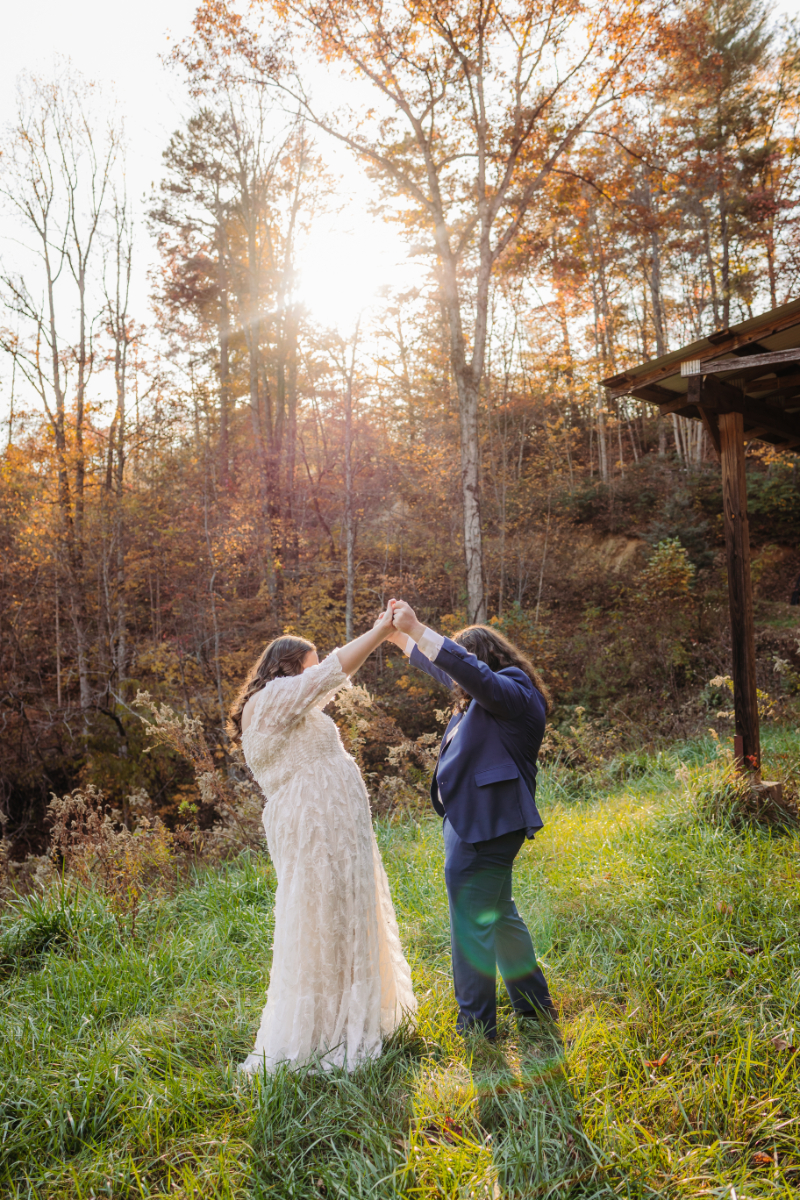 Bride and groom twirl each other after they exchange vows during North Carolina outdoor elopement.