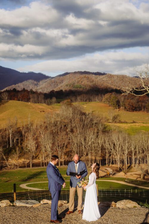 an outdoor wedding ceremony overlooking rolling hills of asheville