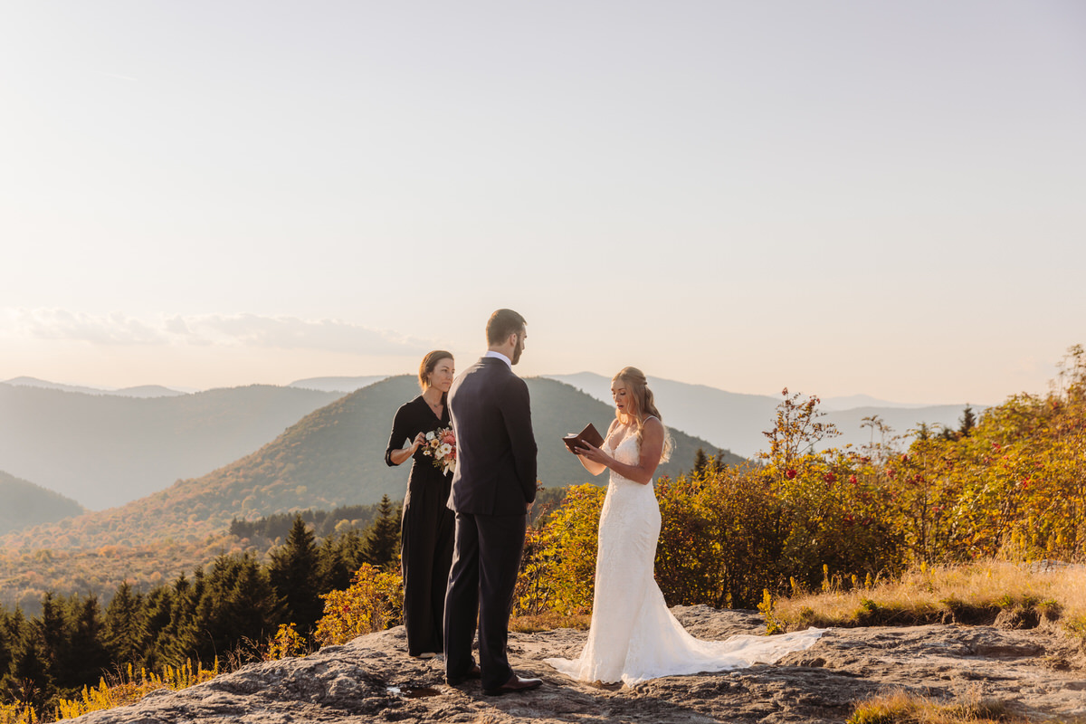 Intimate elopement ceremony on Black Balsam Knob, with a couple exchanging vows atop a scenic mountain ridge, surrounded by breathtaking Blue Ridge Mountain views.