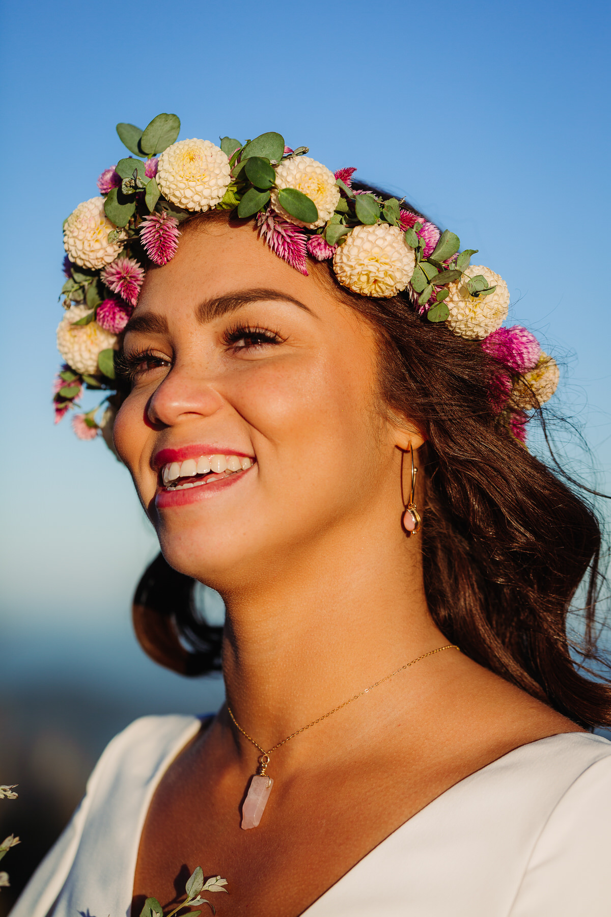 Joyful bride embracing the beauty of her outdoor elopement, radiating freedom and happiness as she explores nature in her flowing gown, surrounded by breathtaking mountain view