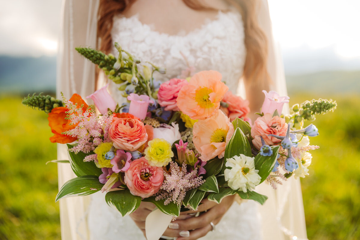 Vibrant summer elopement bouquet with bold, colorful flowers.