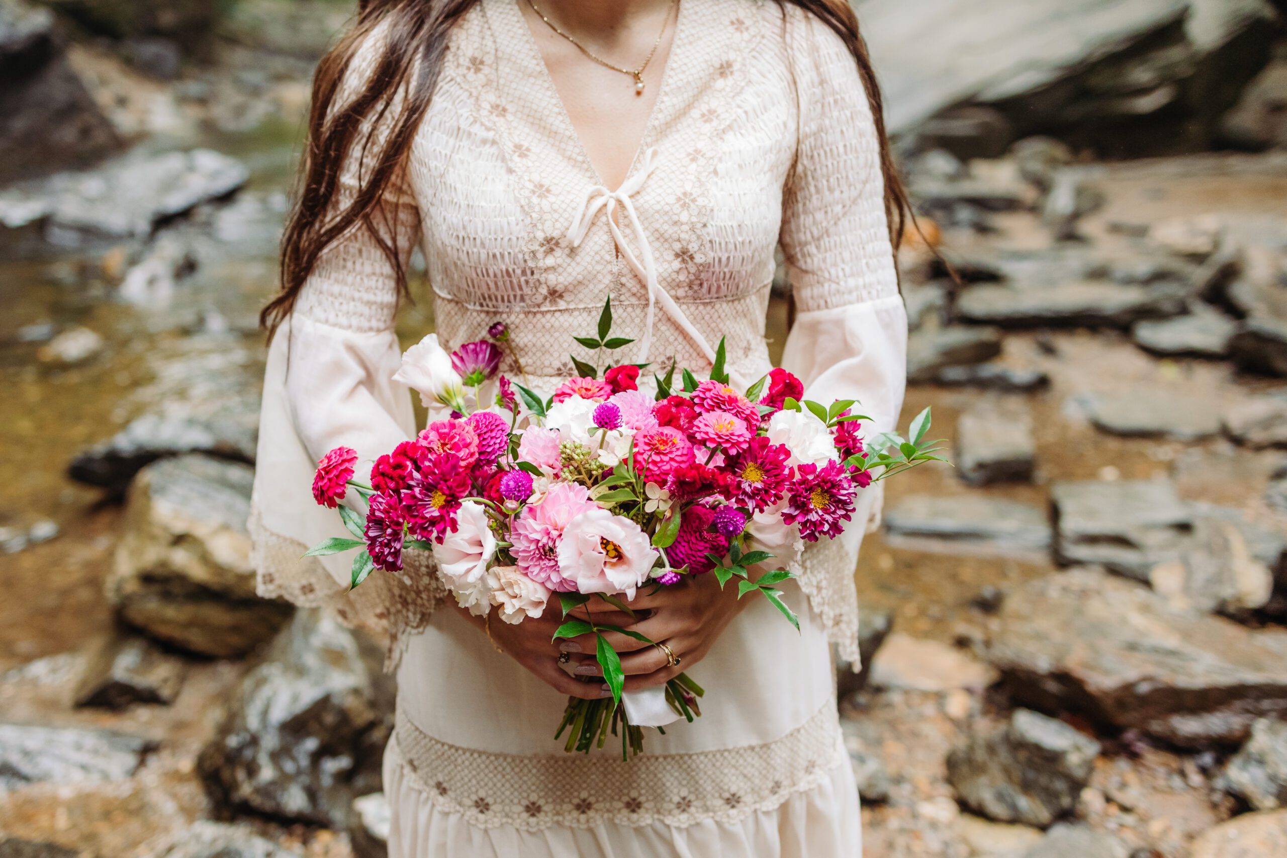 A collection of images showcasing the highlights of a couple’s waterfall elopement day—an intimate ceremony, the bride’s bouquet, the groom’s boutonniere, and other special moments, all set against the backdrop of lush greenery and the stunning waterfall.