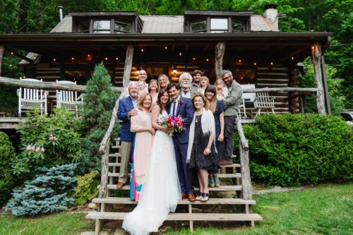  Family members sharing a joyful moment during a mountaintop elopement near Asheville