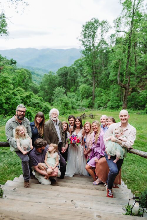  Family members sharing a joyful moment during a mountaintop elopement near Asheville