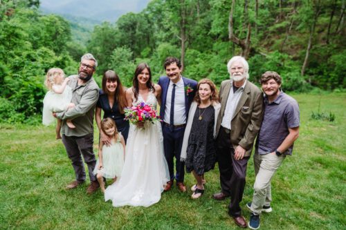  Family members sharing a joyful moment during a mountaintop elopement near Asheville