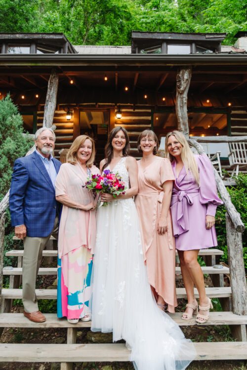  Family members sharing a joyful moment during a mountaintop elopement near Asheville