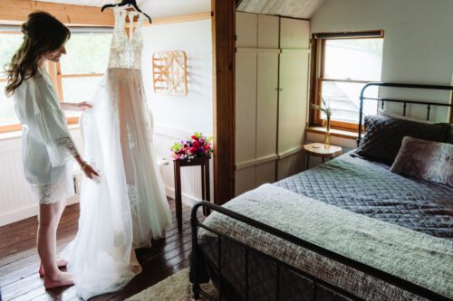 Bride getting ready inside cozy mountain cabin before elopement