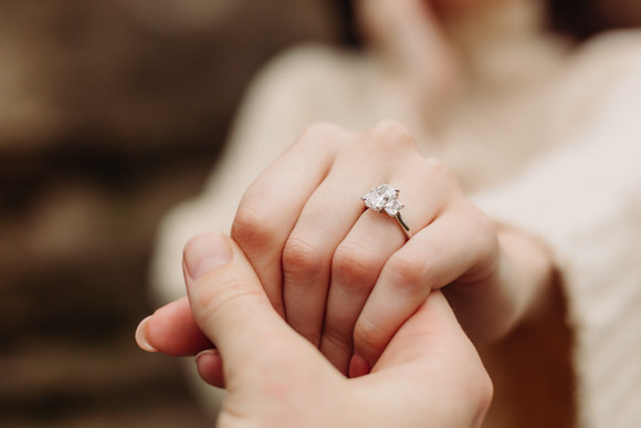 Close-up of engagement ring on hand.