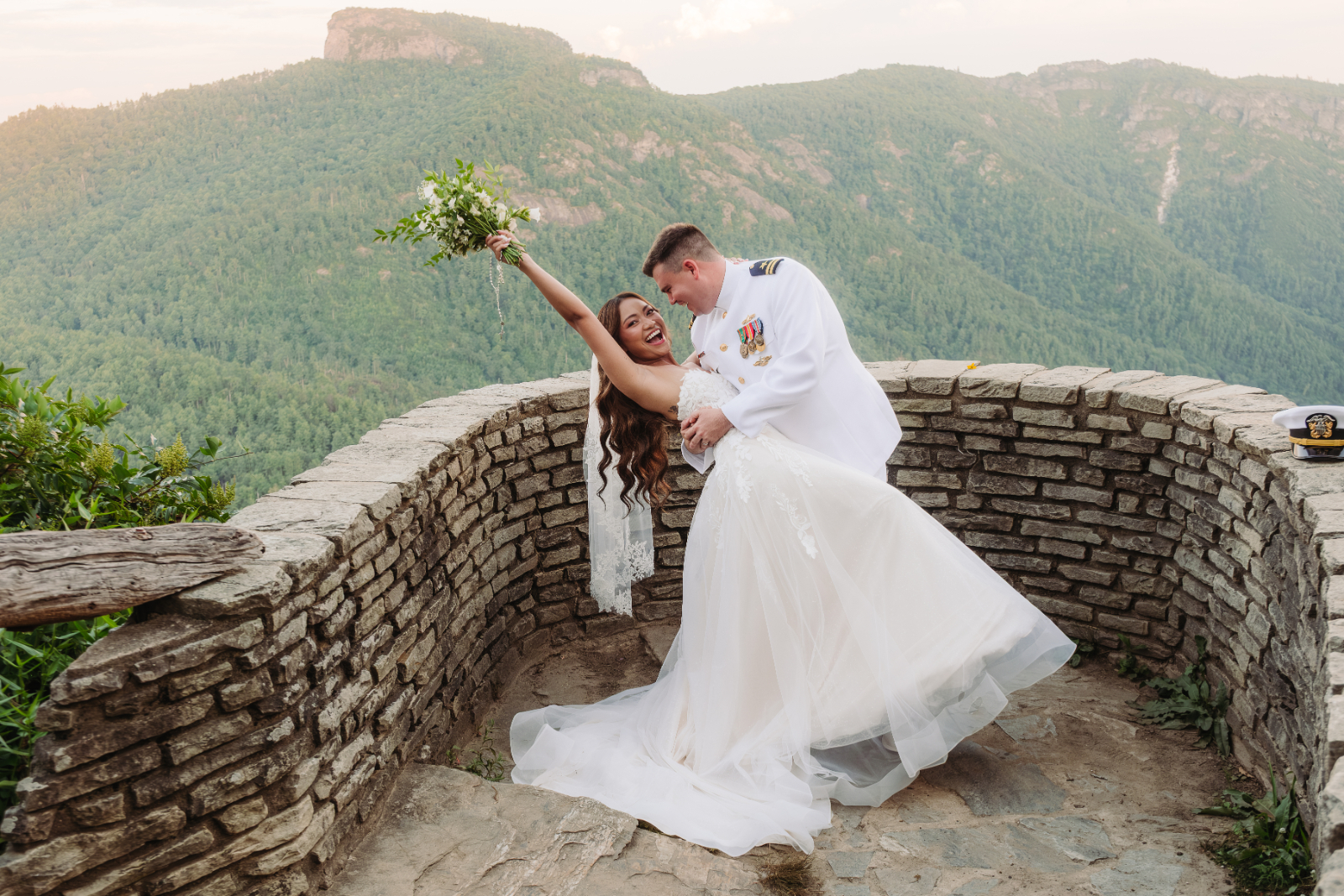 At a mountain overlook, a couple celebrates their Asheville elopement with sweeping Blue Ridge views.