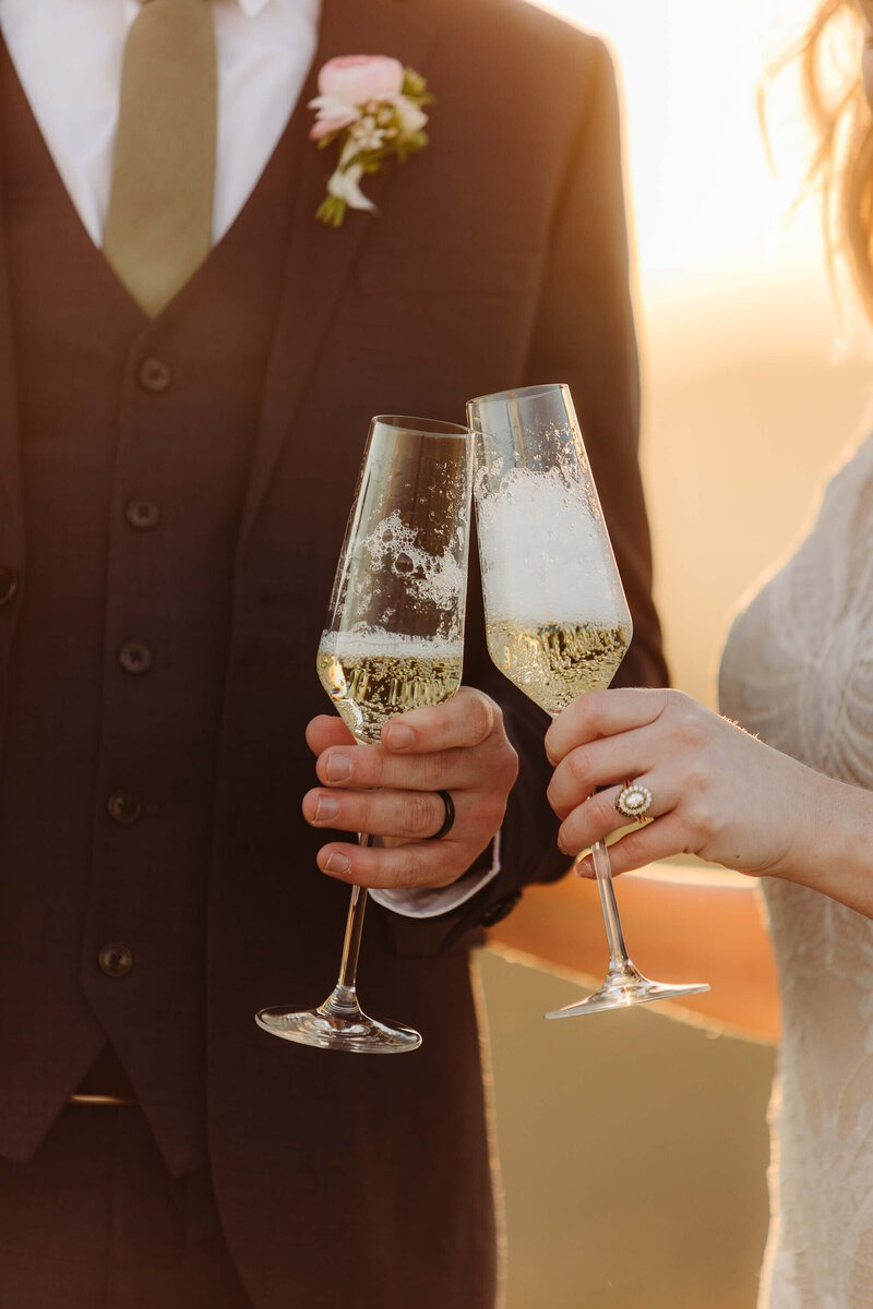 Close-up of couple toasting champagne at sunset, beautifully captured by our Vendor Dream Team in Asheville.