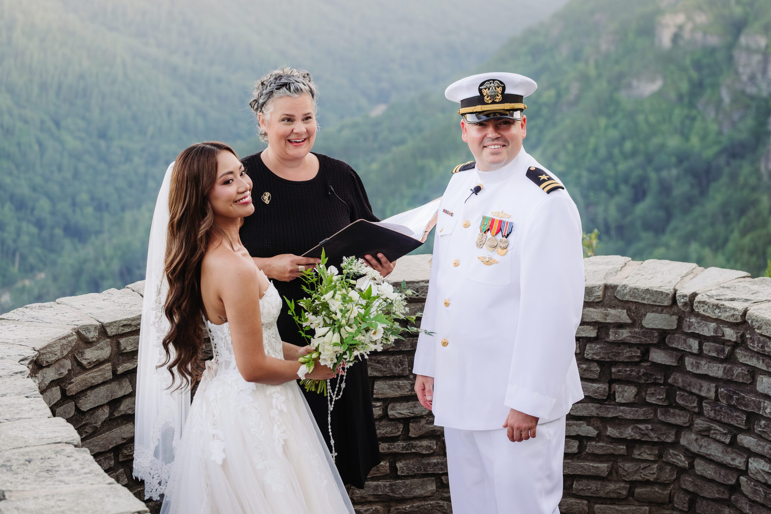 Bride and groom with officiant during mountain ceremony, capturing love and elevating your elopement experience.