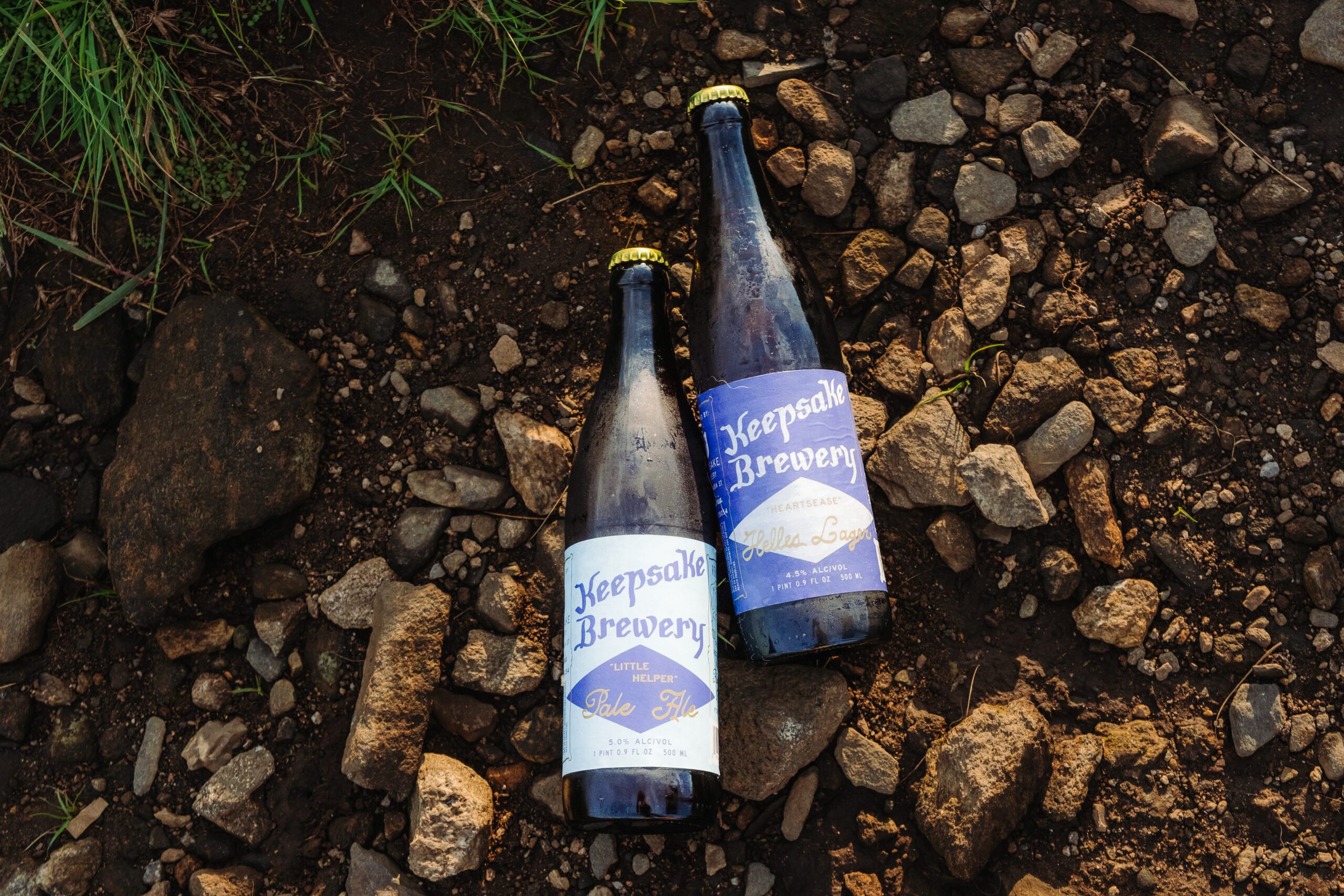 Craft beer bottles from Keepsake Brewery on rocky ground show how to incorporate personal touches into your elopement.