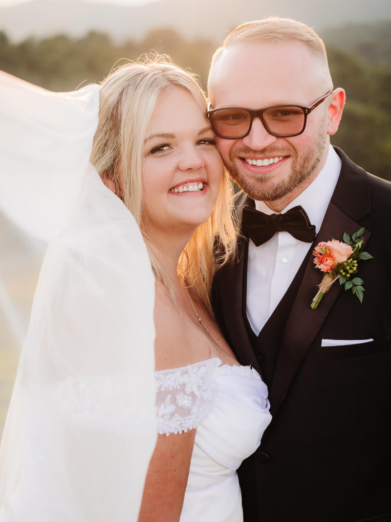 Bride and groom smiling during a golden hour day-after wedding photo session in the Blue Ridge Mountains.