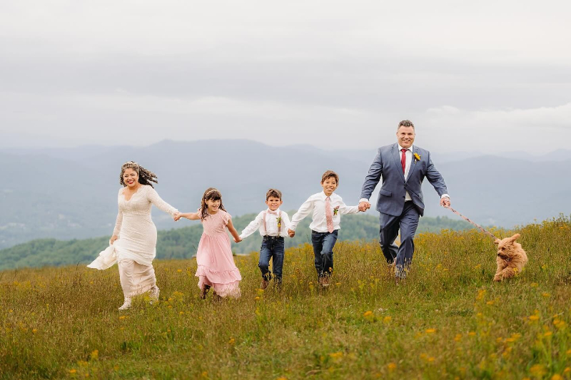 Family includes their dog in their Asheville elopement on a mountaintop with sweeping scenic views.