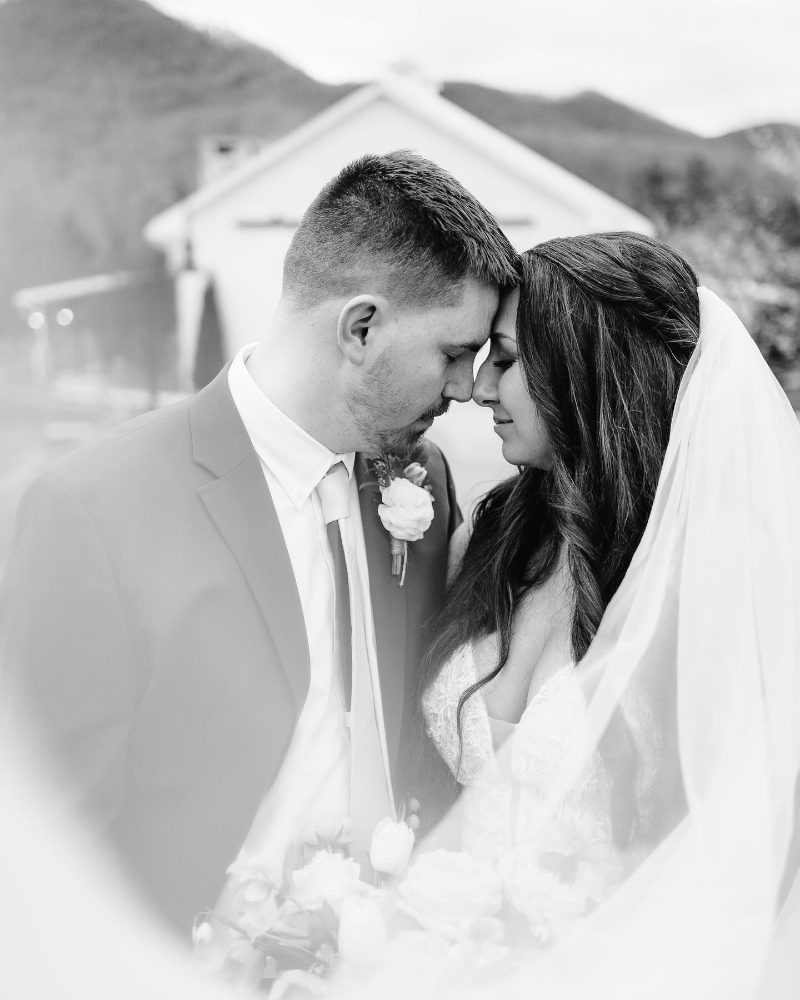 Bride and groom share a quiet moment, captured beautifully in black and white elopement films.