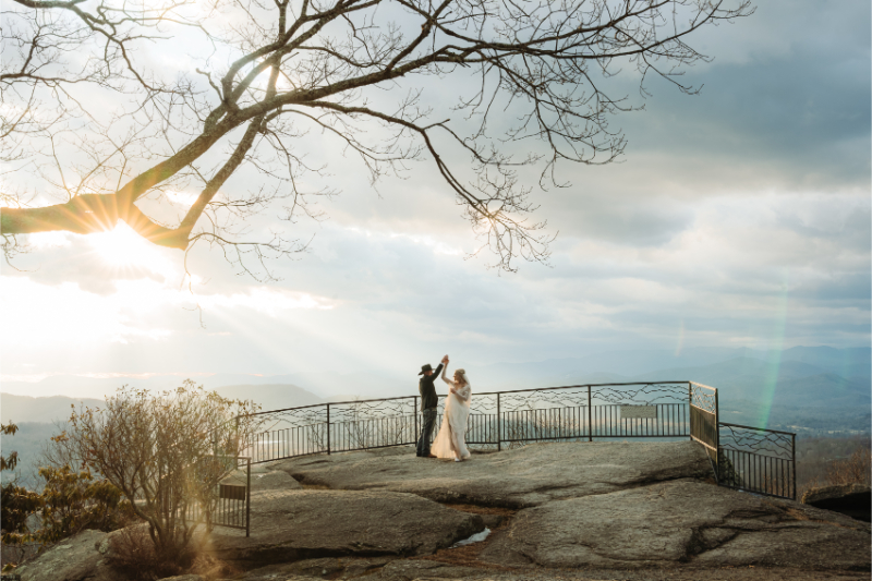 North Carolina mountain wedding couple dancing at sunset overlook with dramatic Blue Ridge views.