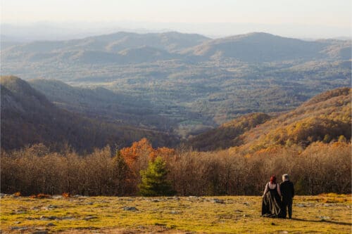 Couple overlooking mountain valley during adventure in North Carolina elopement.
