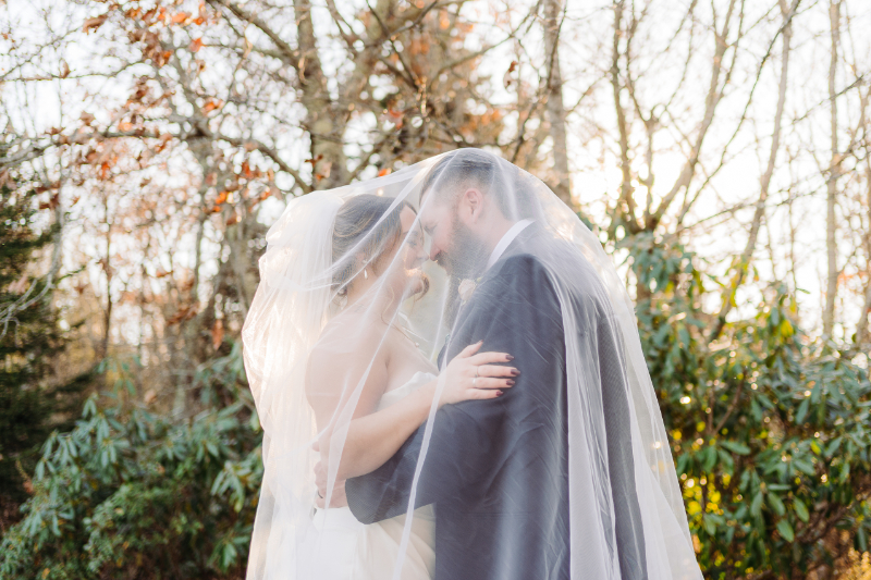 Bride and groom sharing a quiet moment under a veil during a forest elopement in Asheville NC.