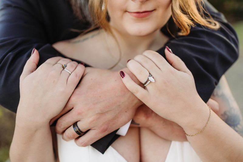 Hands with wedding rings during an intimate elopement in Asheville NC, close up of couple embracing.