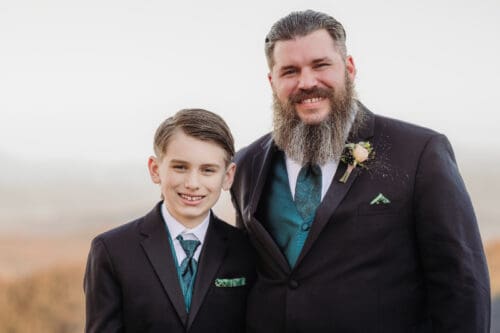 Groom and young boy smiling together during a family moment at an elopement in Asheville NC.