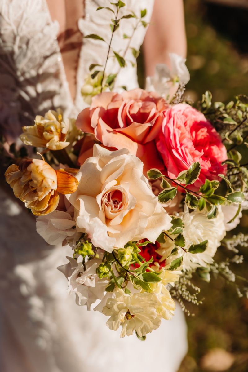 Elopement planning bouquet with soft neutral and coral flowers, natural light mountain wedding details