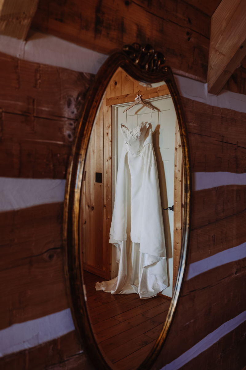 Wedding dress hanging in rustic cabin, perfect for places to elope in Asheville NC