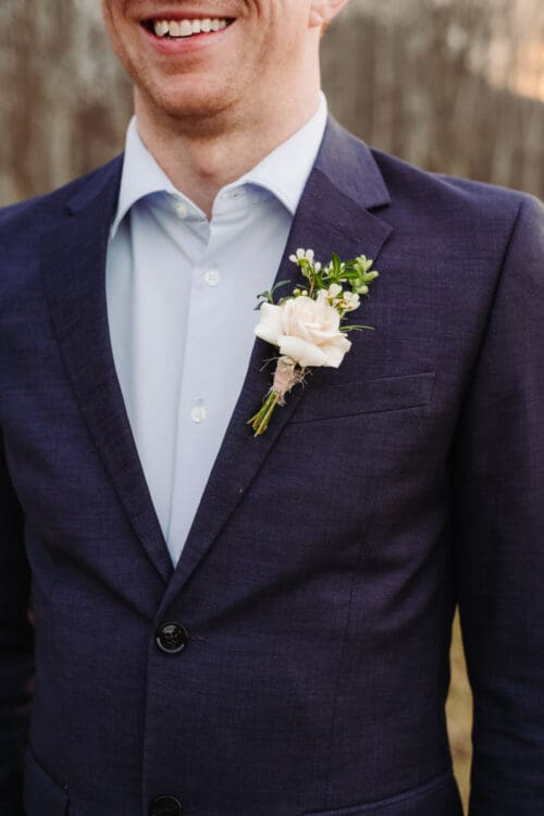 Groom detail with boutonniere on suit jacket, classic style for places to elope in Asheville NC