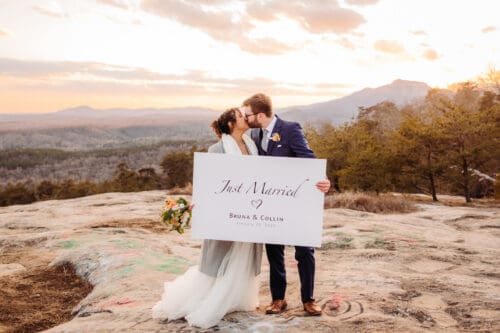 Couple holding Just Married sign after Asheville NC elopement ceremony