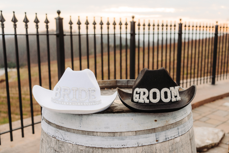 elopement checklist with groom hats on rustic barrel at mountain venue ceremony setting