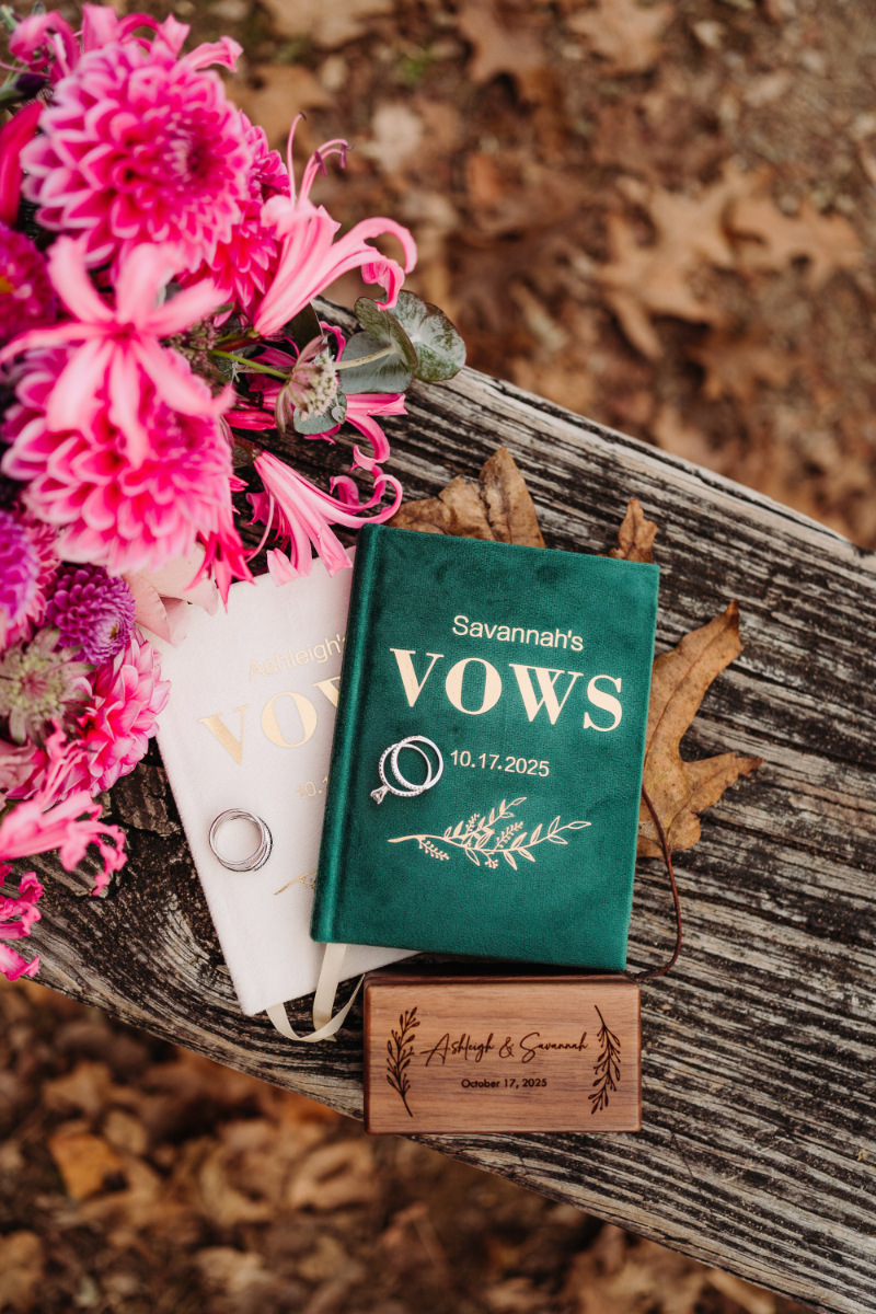 elopement checklist vow books with flowers on wooden table romantic ceremony details