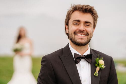 Groom portrait during a remote elopement in the Blue Ridge Mountains with natural light and mountain backdrop.