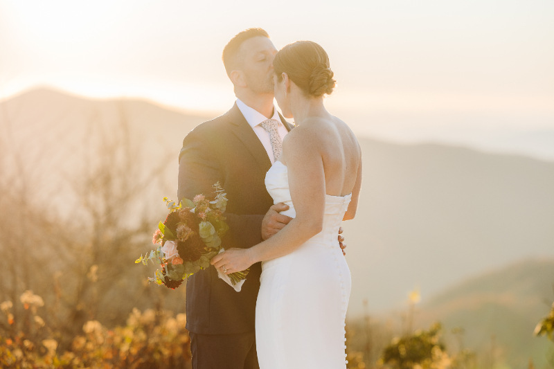 Couple embracing in golden light during sunrise vs sunset elopement in the Blue Ridge Mountains