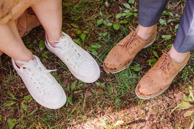 Close up of casual wedding shoes on a forest trail during an outdoor mountain elopement