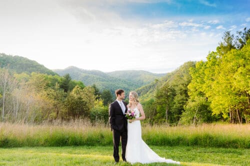 Bride and groom sharing a quiet moment at a scenic mountain overlook near Hot Springs NC during their intimate elopement.