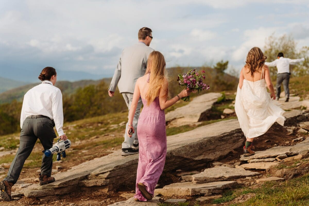 Natalie and Charles hike across Bearwallow Mountain with their three children before their Asheville elopement ceremony.
