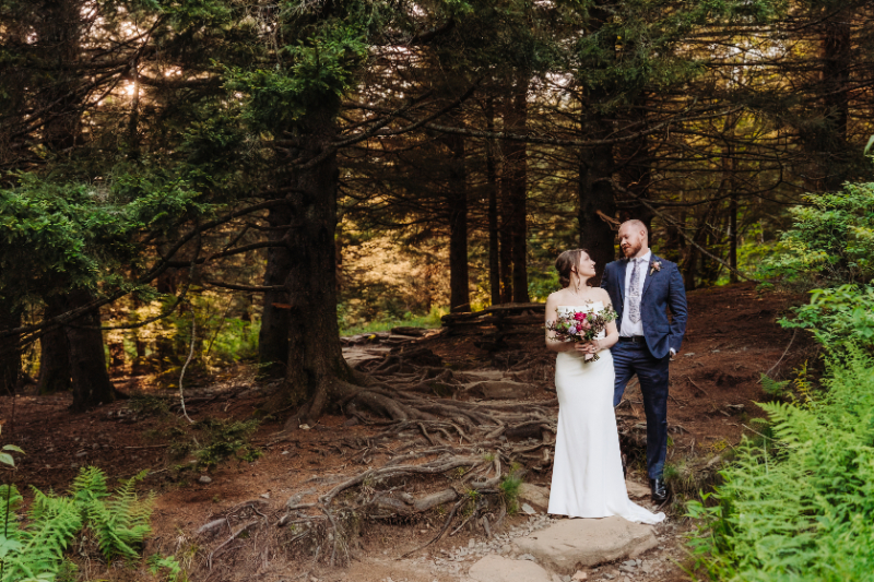 Couple sharing a quiet moment during an elopement in North Carolina surrounded by forest trees.