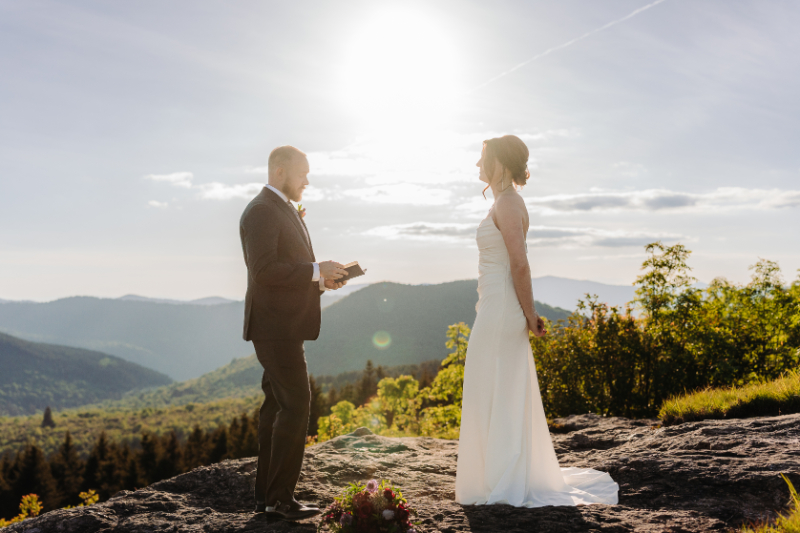 Couple exchanging private vows during an elopement in North Carolina with Blue Ridge Mountain views.