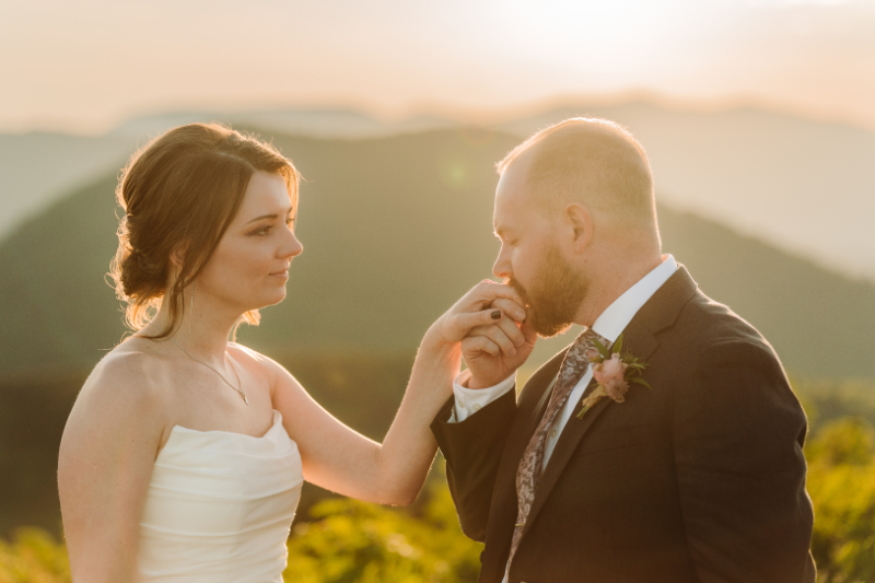 Bride gently touching groom's face during a quiet moment before their ceremony.