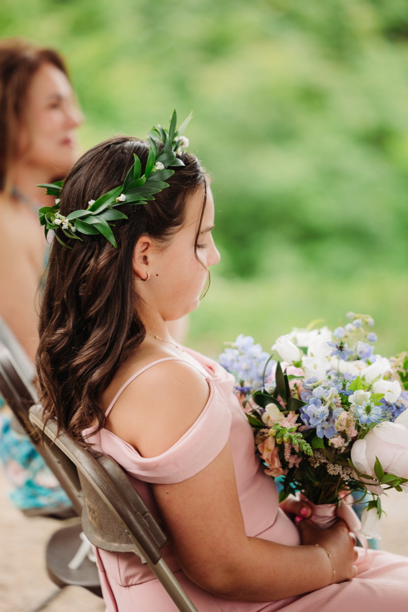 Child holding a bouquet during an elopement with family ceremony in the Blue Ridge Mountains.