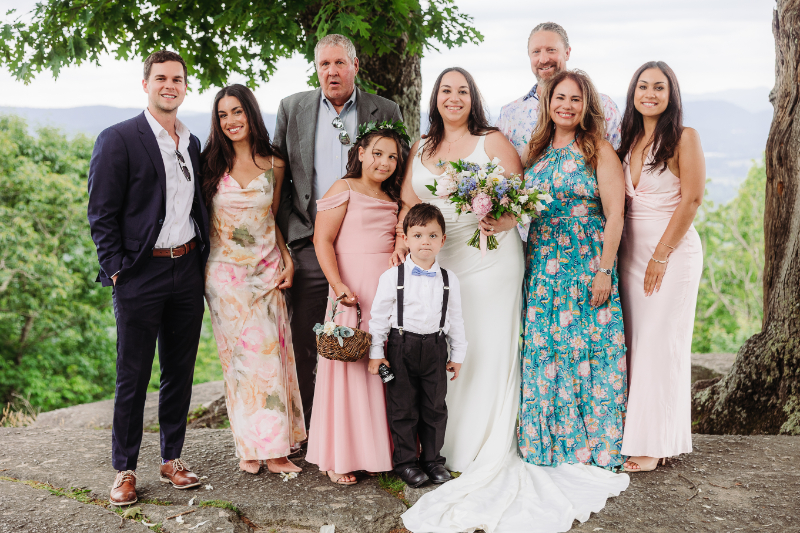 Elopement with family in the Blue Ridge Mountains, featuring couple, relatives, and children together outdoors.