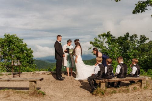Family gathered for an anniversary vow renewal ceremony overlooking the scenic Blue Ridge Mountains near Asheville.
