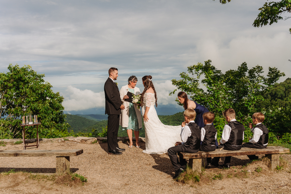 Family gathered for an anniversary vow renewal ceremony overlooking the scenic Blue Ridge Mountains near Asheville.
